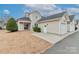 Tan siding home with attached garage and landscaping at 201 Waterlynn Ridge Rd # E, Mooresville, NC 28117