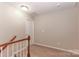 Upstairs hallway with neutral walls and carpet, leading to bedrooms at 201 Waterlynn Ridge Rd # E, Mooresville, NC 28117