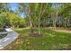 Landscaped backyard with a walkway and mature trees at 209 E Glenview Dr, Salisbury, NC 28147