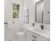 Bright bathroom boasts a white vanity, toilet and a frameless mirror at 209 E Glenview Dr, Salisbury, NC 28147