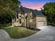 Two-story brick home with a three-car garage and landscaped lawn at 209 E Glenview Dr, Salisbury, NC 28147