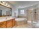 Bathroom boasts a soaking tub, shower, and updated vanity at 209 Squirrel Ln, Lake Wylie, SC 29710