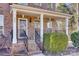 Front porch with brick steps, white columns, and black railing at 209 Squirrel Ln, Lake Wylie, SC 29710