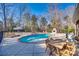 Inviting pool area with stone fireplace and patio at 209 Squirrel Ln, Lake Wylie, SC 29710