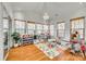 Sun-drenched sunroom with hardwood floors and plenty of natural light at 209 Squirrel Ln, Lake Wylie, SC 29710