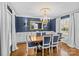 Elegant dining room with blue walls, hardwood floors, and a chandelier at 2228 Valencia Ter, Charlotte, NC 28226