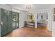 Entryway with brick flooring, green door, and a large round mirror at 2228 Valencia Ter, Charlotte, NC 28226