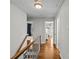 Upstairs hallway with hardwood floors and staircase at 2228 Valencia Ter, Charlotte, NC 28226