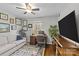 Home office with hardwood floors, built-in desk, and large TV at 2228 Valencia Ter, Charlotte, NC 28226