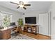 Bright home office featuring hardwood floors, a large desk and TV at 2228 Valencia Ter, Charlotte, NC 28226