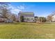 Back exterior view of charming house with deck and yard at 2228 Valencia Ter, Charlotte, NC 28226