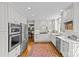 Kitchen with white cabinets, stainless steel appliances, and marble countertops at 2228 Valencia Ter, Charlotte, NC 28226