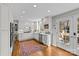 Kitchen with white cabinets, stainless steel appliances, and hardwood floors at 2228 Valencia Ter, Charlotte, NC 28226