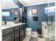 Double vanity bathroom with a soaking tub and dark blue walls at 2262 Galloway Sw Ln, Concord, NC 28025