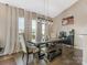 Bright dining room with a farmhouse table and bench, and light beige walls at 2262 Galloway Sw Ln, Concord, NC 28025