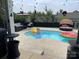 Backyard pool area with outdoor seating, umbrella, and fun floatation devices under a partly cloudy sky at 2262 Galloway Sw Ln, Concord, NC 28025