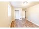 Bedroom with wood-look flooring and a partially damaged wall at 2331 Celia Ave, Charlotte, NC 28216