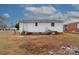 Rear view of the house showcasing a yard and AC unit at 2331 Celia Ave, Charlotte, NC 28216