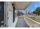 Front porch with wooden railing and street view at 2331 Celia Ave, Charlotte, NC 28216