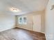 Living room with two windows and wood-look flooring at 2331 Celia Ave, Charlotte, NC 28216