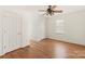 Simple bedroom with hardwood floors and ceiling fan at 2400 Potter Downs Dr, Waxhaw, NC 28173