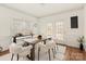 Dining area with wooden table, white chairs, and access to a deck at 2400 Potter Downs Dr, Waxhaw, NC 28173