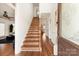 Bright entryway with hardwood floors and wooden staircase at 2400 Potter Downs Dr, Waxhaw, NC 28173