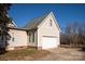 Detached garage with white door and light beige siding at 2400 Potter Downs Dr, Waxhaw, NC 28173