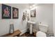 Stylish powder room with pedestal sink and unique wall art at 324 Mill Ridge Rd, Rock Hill, SC 29730