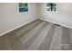 Simple bedroom with neutral carpeting and two windows at 333 S High St, Waxhaw, NC 28173