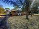 Brick ranch house with landscaped yard and fenced-in area at 333 S High St, Waxhaw, NC 28173