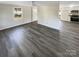 Open living area with wood-look floors, and view into kitchen at 333 S High St, Waxhaw, NC 28173