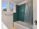 Bathroom with teal tile and a shower/tub combo at 357 7Th Nw St, Hickory, NC 28601