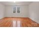 Hardwood floors and neutral walls in this bedroom with windows at 357 7Th Nw St, Hickory, NC 28601