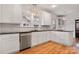 Modern kitchen featuring white cabinets, granite countertops, and stainless steel appliances at 357 7Th Nw St, Hickory, NC 28601