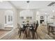 The dining area has stylish lighting, wood floors, and is adjacent to the living spaces with ample sunlight at 3865 Parkers Ferry Rd, Fort Mill, SC 29715