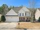 Charming two-story home with manicured lawn, two car garage, and inviting front porch at 3865 Parkers Ferry Rd, Fort Mill, SC 29715