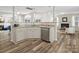 Open kitchen with stainless steel appliances and hardwood floors overlooking the fireplace at 3865 Parkers Ferry Rd, Fort Mill, SC 29715