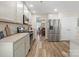 Modern kitchen with stainless steel appliances and hardwood floors leading to dining area at 3865 Parkers Ferry Rd, Fort Mill, SC 29715