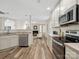 Open kitchen overlooking the living room with stainless steel appliances and hardwood floors at 3865 Parkers Ferry Rd, Fort Mill, SC 29715