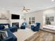 Spacious living room featuring a fireplace, ceiling fan, and comfortable blue furniture at 3865 Parkers Ferry Rd, Fort Mill, SC 29715