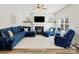 Cozy living room featuring a fireplace, ceiling fan, and comfortable blue furniture at 3865 Parkers Ferry Rd, Fort Mill, SC 29715