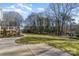 Landscaped backyard with a concrete walkway at 3935 Black Sycamore Dr, Charlotte, NC 28226