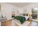 Spacious bedroom with a green duvet and hardwood floors at 3935 Black Sycamore Dr, Charlotte, NC 28226