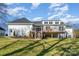 Back exterior of the house showcasing a deck and landscaping at 3935 Black Sycamore Dr, Charlotte, NC 28226