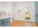 Bright laundry room with blue cabinets and backyard view at 3935 Black Sycamore Dr, Charlotte, NC 28226