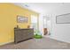 Bedroom with yellow walls, dresser and access to bathroom at 4152 Broadstairs Sw Dr, Concord, NC 28025