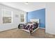 Cozy bedroom with blue accent wall and carpet flooring at 4152 Broadstairs Sw Dr, Concord, NC 28025