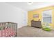 Bright bedroom with yellow walls and lots of natural light at 4152 Broadstairs Sw Dr, Concord, NC 28025