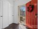 Bright entryway with red door and hardwood floors at 4152 Broadstairs Sw Dr, Concord, NC 28025